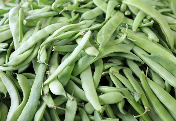 Organic string beans on a market. Green string beans pattern.