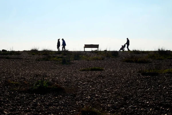 Förgrunden Stenstrand Slutet Stranden Tre Oigenkännlig Människor Promenader Till Vänster — Stockfoto
