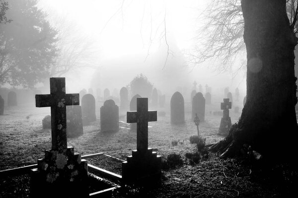 black and white photograph of an English grave yard covered in t