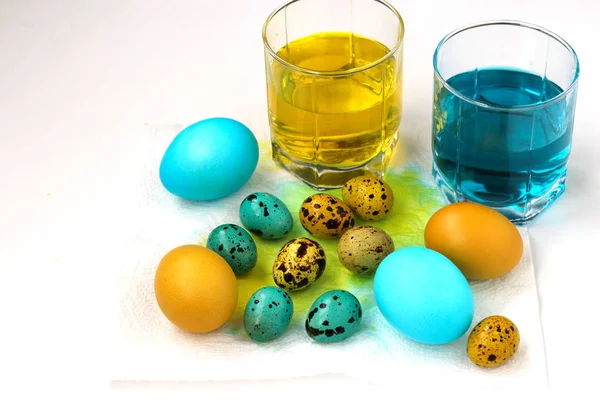 Yellow and blue chicken and quail eggs for Easter, Spring holiday concept