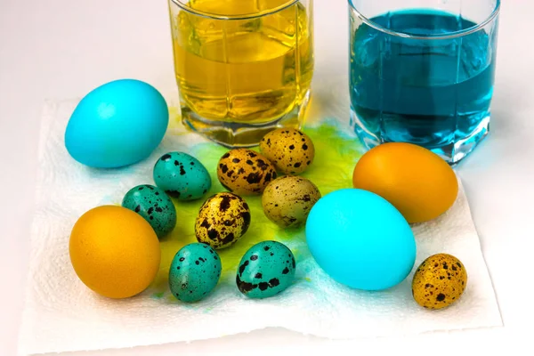 Yellow and blue chicken and quail eggs for Easter, Spring holiday concept