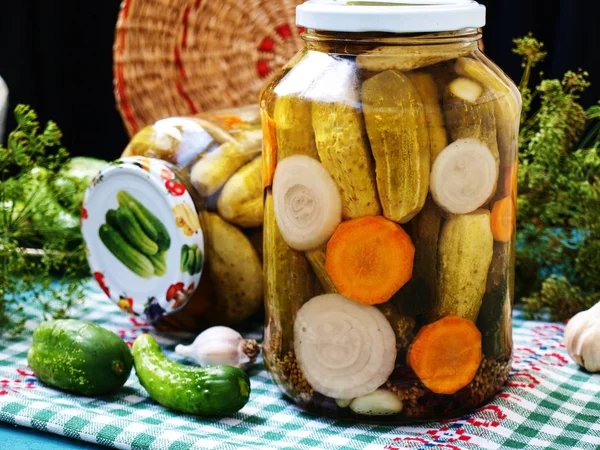 Homemade marinated cucumbers with carrots and onions in a jar — Stock Photo, Image
