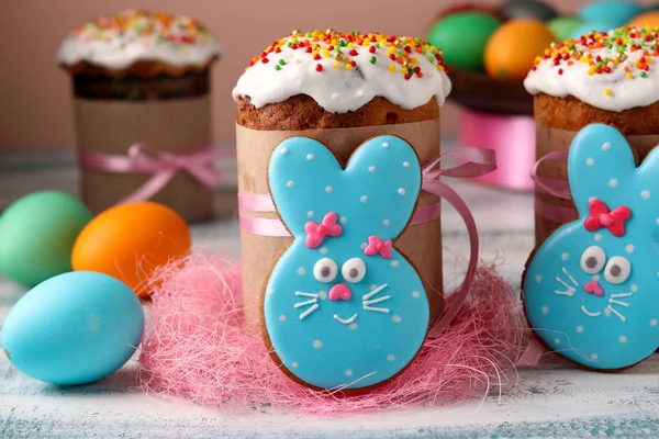 Easter funny rabbits, homemade painted gingerbread biscuits in glaze and Easter cakes, colorful eggs