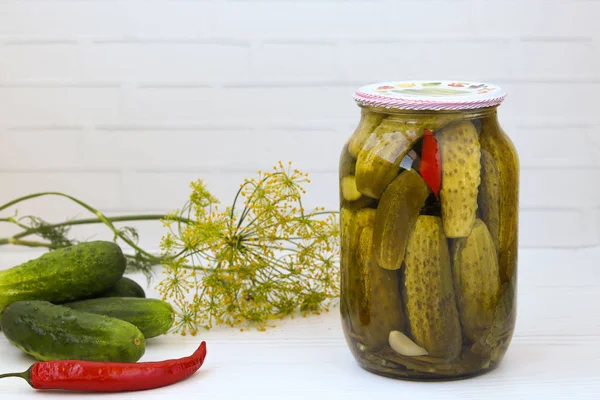 Marinated cucumbers in jars on a white background, Free place for the inscription — Stock Photo, Image