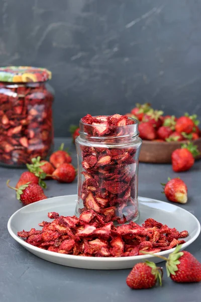 Chipsuri de căpșuni sunt într-un borcan de sticlă pe un fundal întunecat, alimente sănătoase — Fotografie, imagine de stoc