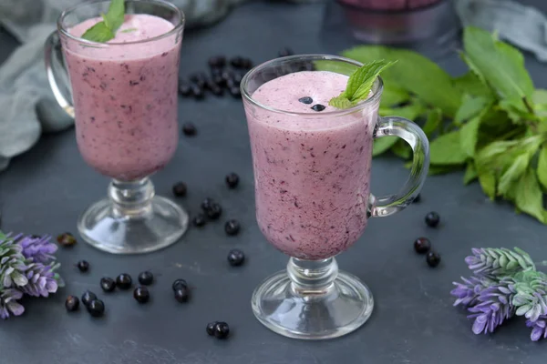 Nutritious cocktail with yogurt and blueberries located in glasses on a dark background, Healthy eating — Stock Photo, Image