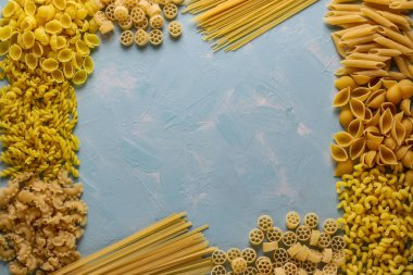 Assorted Italian pasta: Penne rigate, Rotelle, Conchiglie, Cavatappu, Fusilli, Cellentani Spaghetti, horizontal orientation, top view, closeup, copy space clipart