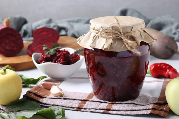 Homemade caviar from beets and apples in glass jar and bowl on light gray background, Horizontal format — Stock Image Homemade Caviar Beets Apples Glass Jar Bowl Light Gray Background Stock Image