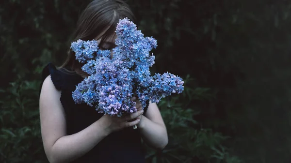 Cute little girl smelling lilac — Stock Photo, Image