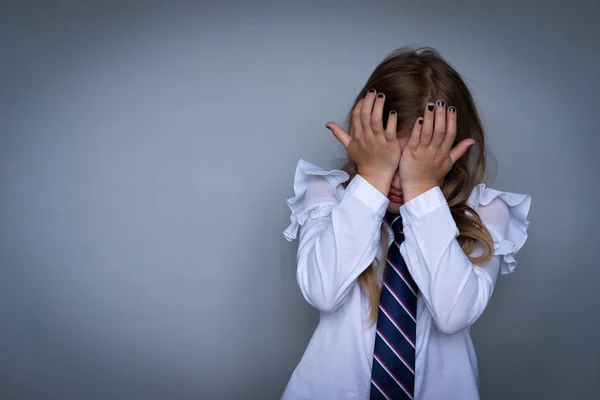 Small schoolgirl covering face, crying portrait — Stock Photo, Image