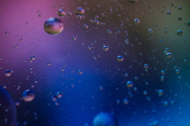 Bardaktaki berrak suda sebze yağı kabarcıkları ve renkli kağıttaki kızartma tavasının şeffaf kapağı..