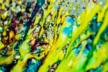 Yazıcı kartuşunu doldurmak için kullanılan mürekkep beyaz lavabonun üzerine dökülmüş ve boyalar soyut damlalar ve desenlerle harmanlanmış..