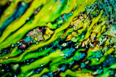 Yazıcı kartuşunu doldurmak için kullanılan mürekkep beyaz lavabonun üzerine dökülmüş ve boyalar soyut damlalar ve desenlerle harmanlanmış..