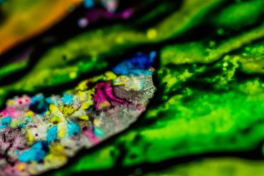 Yazıcı kartuşunu doldurmak için kullanılan mürekkep beyaz lavabonun üzerine dökülmüş ve boyalar soyut damlalar ve desenlerle harmanlanmış..