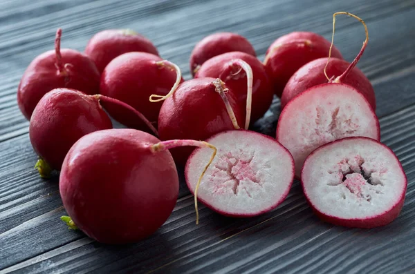 Radish Root Vegetables Lie Black Wooden Table One Them Cut — Stock Photo, Image