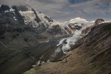 Melting glacier tongue with snow-capped mountains at Grossglockner in Carinthia, Austria