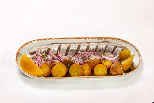 Fried potatoes and low-salted herring and onion rings