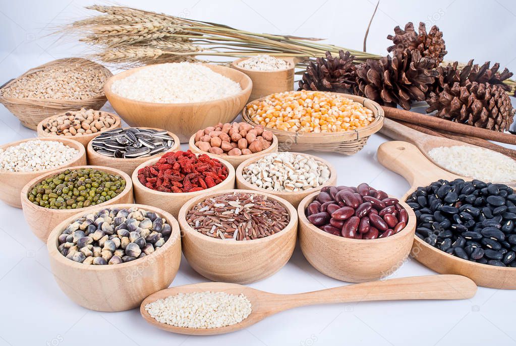 Cereal grains , seeds, beans on wooden background