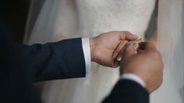 Damat gelini parmağında alyans koyar. Evlilik yüzükler elleriyle. Gelin ve damat nikah yüzükleri değişimi.