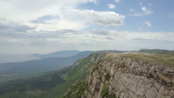 Vuelo a lo largo de un acantilado en las montañas de Crimea. Increíble vista aérea de rocas, bosques y mar en Crimea — Vídeos de Stock