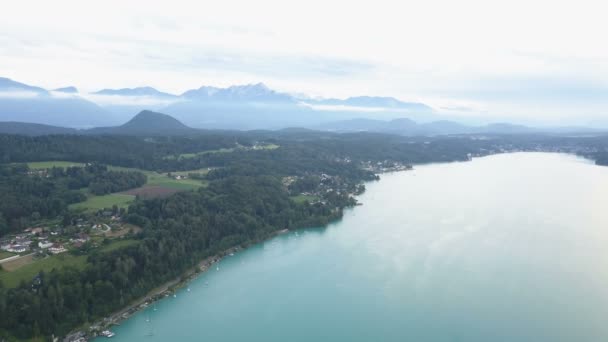 Aerial view of a big lake in mountains. Klagenfurt Carinthia Austria. — Stockvideo