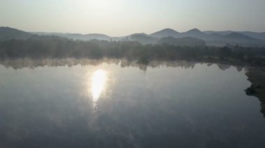 Bir sabah sis bir dağ Gölü üzerinde aracılığıyla sinematik hava sinek. Dağlarda sisli gündoğumu.