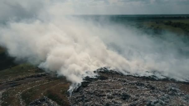 El basurero contamina el medio ambiente. Viento fuerte eleva humo tóxico de basura ardiendo en el aire . — Vídeo de stock