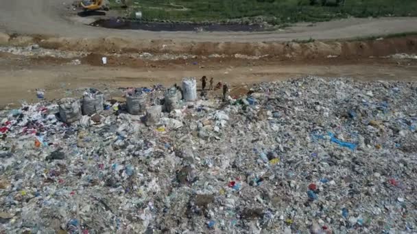 Vista aérea del basurero de la ciudad. Familia gitana con niños separa la basura para ganar algo de dinero — Vídeo de stock