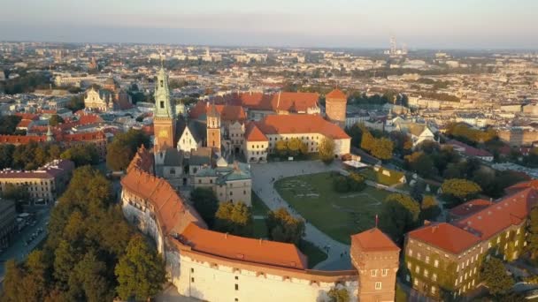 Aerial view of Royal Wawel Cathedral and castle in Krakow, Poland, with Vistula river, park, yard and tourists at sunset. Old city in the background — Stock Video