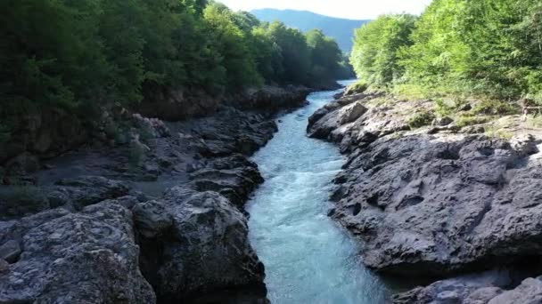 Aerial drone shot of a fast white alpine river. Beautiful view of mountain river Belaya on summer sunny morning in mountains of Adygea, Russia. — Stock Video