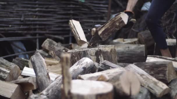 Mann hackt Holz im Freien in Zeitlupe. Menschenhände, die mit Axt arbeiten. Holzfäller hackt Baumstämme mit Axt für Brennholz. — Stockvideo