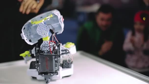 Kharkiv, Ucrania - 09 de noviembre de 2019: Meccano Max robot inclina la cabeza, se mueve frente a los aplausos de los niños en la exposición interactiva de ciencia y entretenimiento. Nuevo modelo de inteligencia artificial . — Vídeo de stock