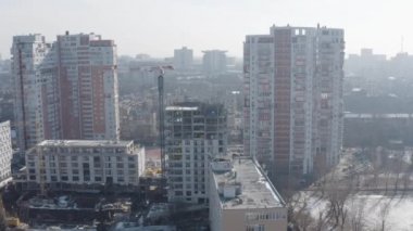 Ukrayna 'nın Kharkov kentinde yaşamak için inşa edilecek yeni evin en iyi manzarası. İkamet binalarının arka planındaki modern ofis binalarıyla şehrin aktif gelişimi.