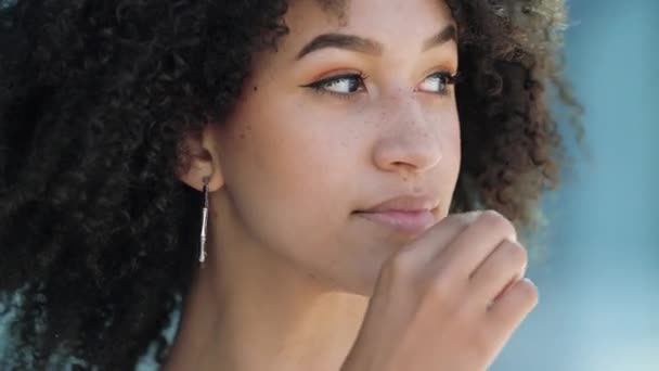 Primer plano retrato de chica afroamericana bonita con afro peinado cremallera labios, la boca de bloqueo. Joven modelo étnico sonríe astutamente, imita tirar la llave, promete guardar secreto, silencio misterioso — Vídeo de stock