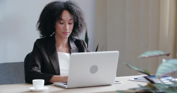 Front view of serious focused female entrepreneur or pretty professional business woman writer sitting at office desk, using laptop for typing. write email, study and surf in internet — Stock Video