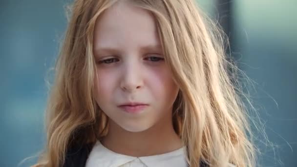 Portrait of upset sleepy little schoolgirl looking at camera with sadness and resentment in her eyes, lonely kid cute lady crying, wiping tear from her face with child hand, negative bad mood concept — Stock Video