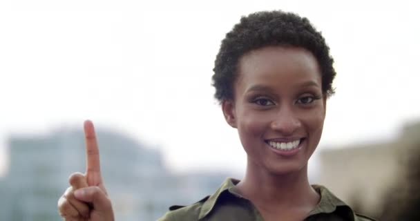 Portrait of stylish teenage girl looking happily at camera, smiling with white teeth, raising her hand up, counting from one to three, extending fingers in turn, report first, second, third close-up — Stock Video