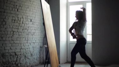 Genç bir kadın sanatçı, geniş fırça ve yağlı boya kullanarak parlak, alışılmadık bir soyut resim yapar. Kız ışık penceresinin önünde dans ediyor, duygusal modern dansı ve yaratıcılığı birleştiriyor.