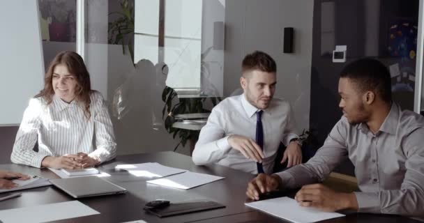 Hombre blanco caucásico hablando con embajador africano socio internacional sobre inversión de negocios discutiendo nuevo proyecto sentado en la mesa con el equipo de colegas profesionales en la oficina de la empresa — Vídeo de stock