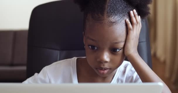 Curious preschool african mixed race girl using laptop on couch, little  smart black kid typing on computer chatting with friends online alone at  home, child security, children and gadget concept Stock Photo