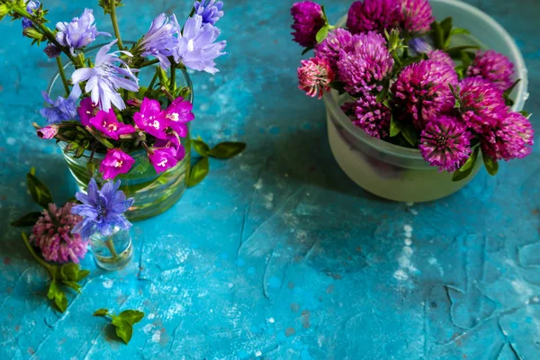 Pink Clover flowers on table with blue background