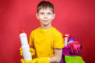 Sarı eldivenli, temizlik malzemeli bir çocuk. 