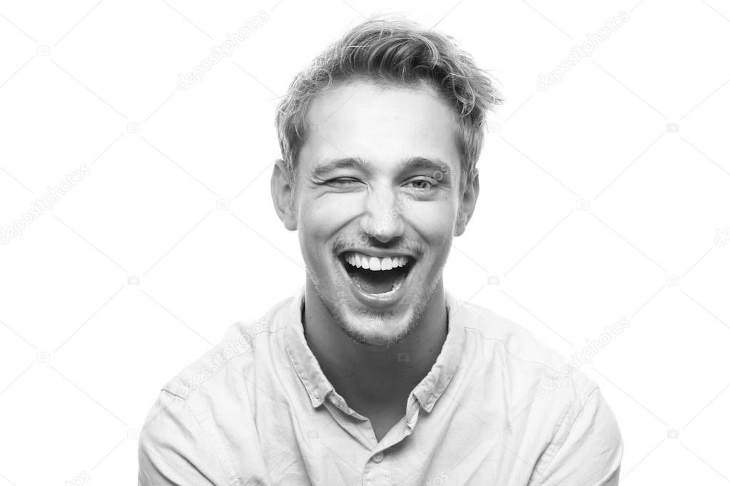 Caucasian young man is winking on black and white tone
