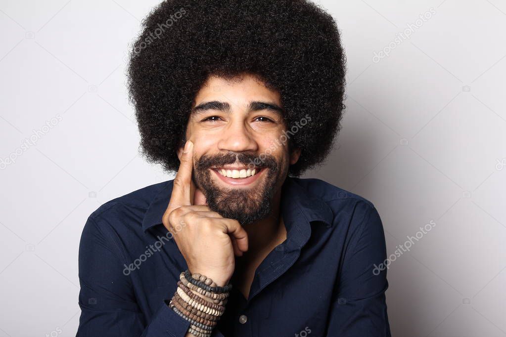 Happy black man posing on white background