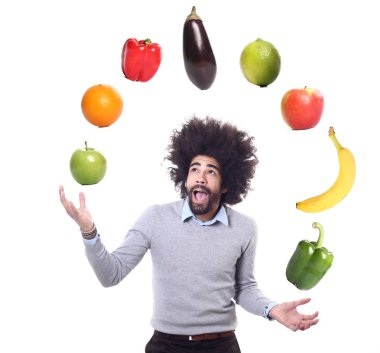 Afro-american man is juggles different fruits and vegetables clipart