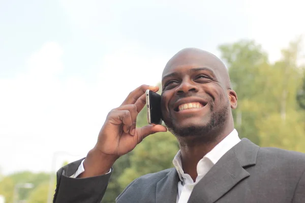 Black businessman talking on mobile phone
