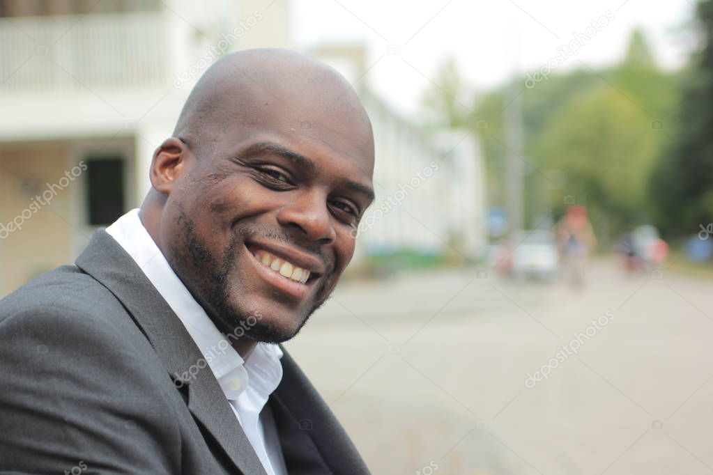 Smiling black businessman outdoors