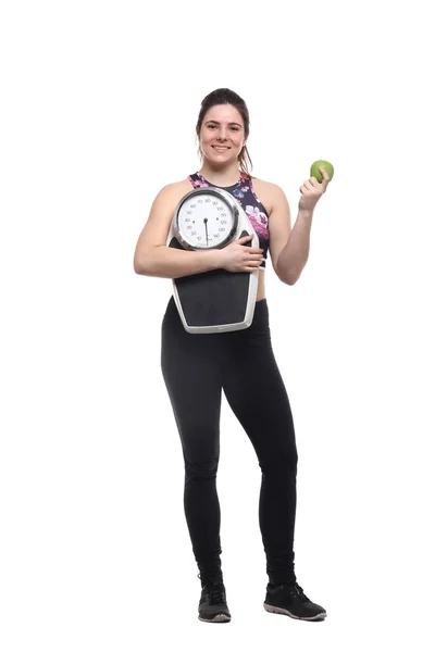 Junge Sportlerin Hält Gewichtswaage Und Isst Apfel — Stockfoto