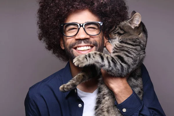 Black man holding cat in hands