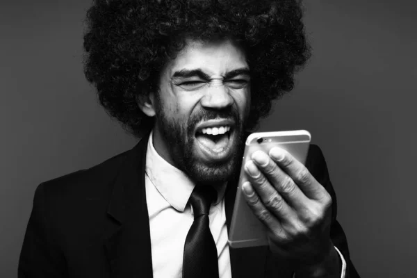 Black businessman using mobile phone on black and white tone